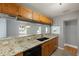 Beautiful kitchen with granite countertops, black appliances, and warm wood cabinets, perfect for cooking and entertaining at 1111 Guernsey St, Orlando, FL 32804