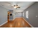 Bright and airy living room with hardwood floors, gray walls, ceiling fan, and seamless flow into the kitchen at 1111 Guernsey St, Orlando, FL 32804