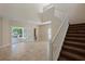 Open living room with high ceilings, tile flooring, and stairs to the second floor at 1111 Guernsey St, Orlando, FL 32804