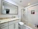 Stylish bathroom with granite vanity top, framed mirror, and walk-in shower offers a spa-like experience at 117 Starling Ln, Longwood, FL 32779