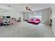 Spacious bedroom with ceiling fan, multiple windows and plush carpeting creates a bright and airy feel at 117 Starling Ln, Longwood, FL 32779