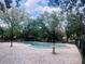 Tranquil Community pool with spacious brick paver lanai and lush landscaping create a peaceful oasis for residents at 117 Starling Ln, Longwood, FL 32779