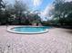 Resort style Community pool with spacious brick paver lanai and lush landscaping provides a relaxing and luxurious experience at 117 Starling Ln, Longwood, FL 32779