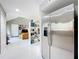 Bright entryway featuring tile floors, stainless steel refrigerator, and an open view to the living area beyond at 117 Starling Ln, Longwood, FL 32779