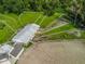 Aerial view of equestrian facility featuring white-fenced paddocks and stables surrounded by beautiful green landscapes at 117 Starling Ln, Longwood, FL 32779