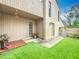 Exterior view of the side yard showcasing a patio, complemented by lush landscaping and a secure gate at 117 Starling Ln, Longwood, FL 32779