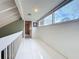 Bright hallway featuring sleek white tile flooring, and a large window with natural light at 117 Starling Ln, Longwood, FL 32779