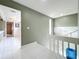 Bright hallway with white tile flooring and neutral paint, connecting different areas of the home at 117 Starling Ln, Longwood, FL 32779