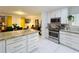 Modern kitchen with granite countertops and stainless steel appliances, flowing into a dining area at 117 Starling Ln, Longwood, FL 32779