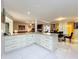 Open kitchen with a breakfast bar, granite countertops, and white cabinetry adjacent to the dining area at 117 Starling Ln, Longwood, FL 32779