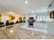 Bright kitchen featuring granite countertops, white cabinetry, and stainless steel appliances, flowing to dining area at 117 Starling Ln, Longwood, FL 32779