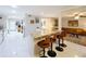 Stylish kitchen island with seating overlooks a spacious, open living area for easy entertaining at 117 Starling Ln, Longwood, FL 32779