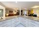 Open kitchen with a granite countertop, white cabinets, and an open floorplan to the living spaces at 117 Starling Ln, Longwood, FL 32779