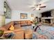 Comfortable living room showcases a leather sectional sofa, stone fireplace, and a large, decorative area rug at 117 Starling Ln, Longwood, FL 32779