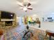 Bright living room featuring a stone fireplace, and sliding glass doors to outside, adjacent to dining and kitchen areas at 117 Starling Ln, Longwood, FL 32779