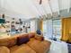 Open-concept living room with tile floors, beamed ceilings, and sliding glass doors to the outdoor patio at 117 Starling Ln, Longwood, FL 32779