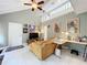 Bright living room with vaulted ceilings, tile floors, and a cozy sofa with lots of artwork on the walls at 117 Starling Ln, Longwood, FL 32779