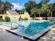 A refreshing community pool with clear blue water, tiled edges, and surrounding landscaping and pool rule signage at 117 Starling Ln, Longwood, FL 32779