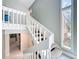 Carpeted staircase featuring painted white railings and an open design to bring in natural light at 117 Starling Ln, Longwood, FL 32779
