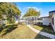 Lush backyard featuring a screened-in pool area and well-manicured lawn at 1231 Glastonberry Rd, Maitland, FL 32751