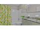 Beautiful bathroom with updated fixtures, lemon shower curtain, and natural light at 1420 Continental Dr, Daytona Beach, FL 32117