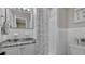 Clean bathroom with a granite vanity top, mirror, updated fixtures, and bright lighting at 1420 Continental Dr, Daytona Beach, FL 32117