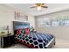 Comfortable bedroom featuring a ceiling fan, a bright window, and stylish decorations at 1420 Continental Dr, Daytona Beach, FL 32117