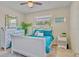 Charming bedroom with white furniture, bright turquoise bedding, and decorative accents at 1420 Continental Dr, Daytona Beach, FL 32117