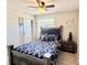 Cozy bedroom featuring laminate flooring, ceiling fan, and double door closet at 1420 Continental Dr, Daytona Beach, FL 32117