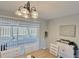 Dining area with chandelier, white brick wall, view to backyard, and decor at 1420 Continental Dr, Daytona Beach, FL 32117