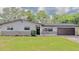 Charming single-story home with a well-manicured lawn and a two-car garage at 1420 Continental Dr, Daytona Beach, FL 32117