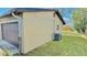 Exterior view of the home highlighting the attached garage, siding, and well-maintained lawn at 1420 Continental Dr, Daytona Beach, FL 32117