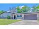 Charming single-story home with a well-manicured lawn and a two-car garage at 1420 Continental Dr, Daytona Beach, FL 32117