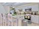 Updated kitchen features white cabinets, granite countertops, stainless steel appliances, and breakfast bar at 1420 Continental Dr, Daytona Beach, FL 32117