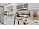 Modern, clean kitchen featuring granite countertops, stainless steel appliances, and bright lighting at 1420 Continental Dr, Daytona Beach, FL 32117