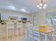Eat-in kitchen with white cabinets, stainless steel appliances, and granite countertops at 1420 Continental Dr, Daytona Beach, FL 32117