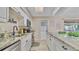 Modern kitchen with white cabinets, granite countertops, stainless appliances, and island with breakfast bar at 1420 Continental Dr, Daytona Beach, FL 32117
