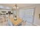Eat-in kitchen with white cabinets and a view to the outside at 1420 Continental Dr, Daytona Beach, FL 32117