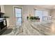Close-up of granite countertop, sink, and kitchen in a well-lit, modern kitchen and dining area at 1420 Continental Dr, Daytona Beach, FL 32117