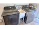Close up of the laundry area with modern Samsung washer, dryer, and utility sink at 1420 Continental Dr, Daytona Beach, FL 32117