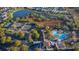 Aerial view of a community pool, tennis courts, clubhouse, and surrounding neighborhood at 145 Old Moss Cir, Deland, FL 32724