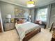 Comfortable bedroom with a large window, stylish decor, and neutral color scheme at 145 Old Moss Cir, Deland, FL 32724