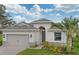 Charming single-story home featuring a two-car garage, stone accents, and a well-maintained lawn at 145 Old Moss Cir, Deland, FL 32724