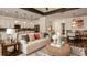 Cozy living room featuring a white sofa, dining space, and direct access to the modern kitchen at 145 Old Moss Cir, Deland, FL 32724
