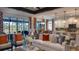 Spacious living room showcasing an open floor plan with a stylish sofa and direct access to the kitchen and patio at 145 Old Moss Cir, Deland, FL 32724