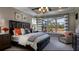 Elegant main bedroom with a large window overlooking the backyard and stylish decor at 145 Old Moss Cir, Deland, FL 32724