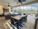 An expansive outdoor patio with a dining table and outdoor lounge with a view of the pool and yard at 145 Old Moss Cir, Deland, FL 32724
