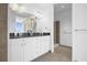 Bathroom featuring dual sinks, white cabinets, granite counters, and glass shower at 150 E Robinson St # 2308, Orlando, FL 32801
