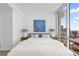 Sunlit bedroom boasts expansive windows with stunning city views, creating a serene and bright atmosphere at 150 E Robinson St # 2308, Orlando, FL 32801