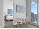Cozy dining area next to bedroom features a small table and chairs with cityscape views at 150 E Robinson St # 2308, Orlando, FL 32801